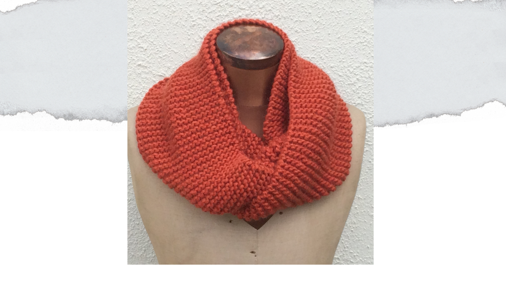 knitted cowl in garter stitch using rust coloured yarn. Wrapped twice around the neck of a sewing dummy. Made from free knitting pattern.