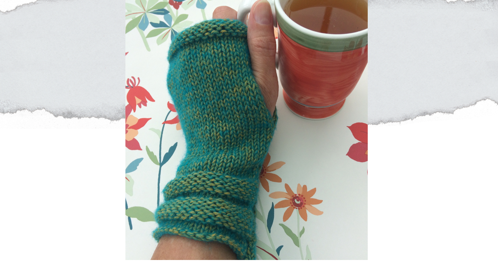 knitted mittens using green yarn. Worn on hand holding a mug