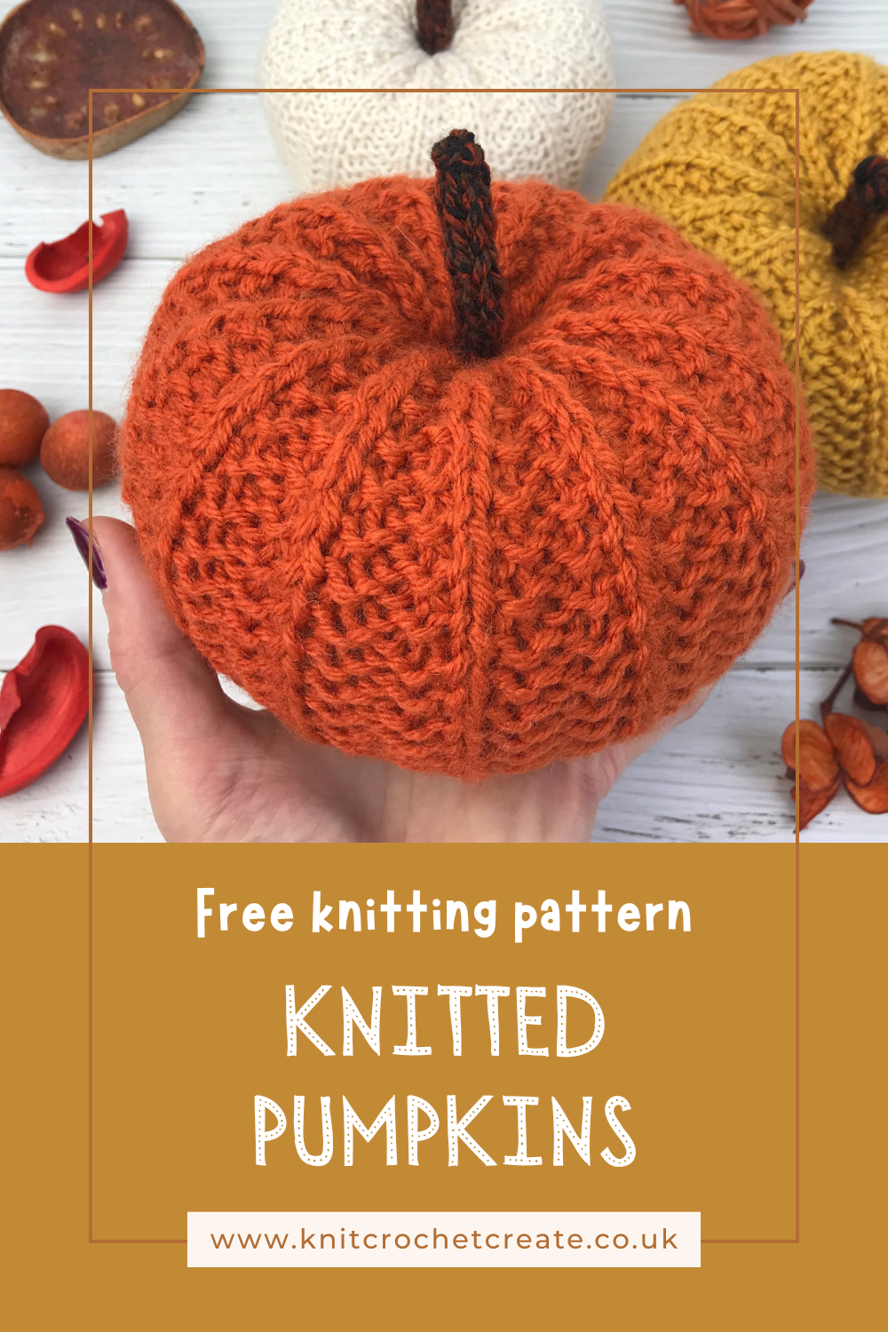 Hand holding a knitted pumpkin in orange yarn, made from free knitted pumpkin pattern by Lynne Rowe