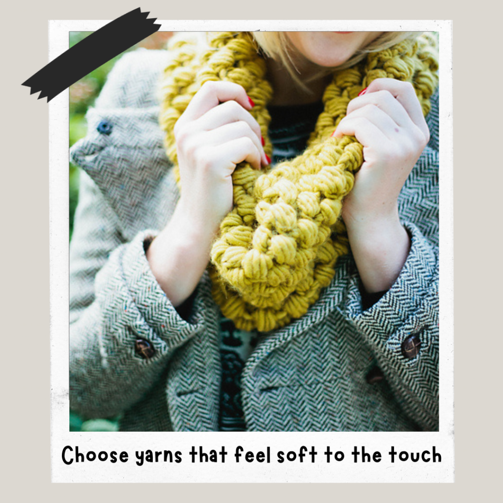 Hands touching a crochet neck cosy, made in a chunky yarn with a tactile stitch pattern.