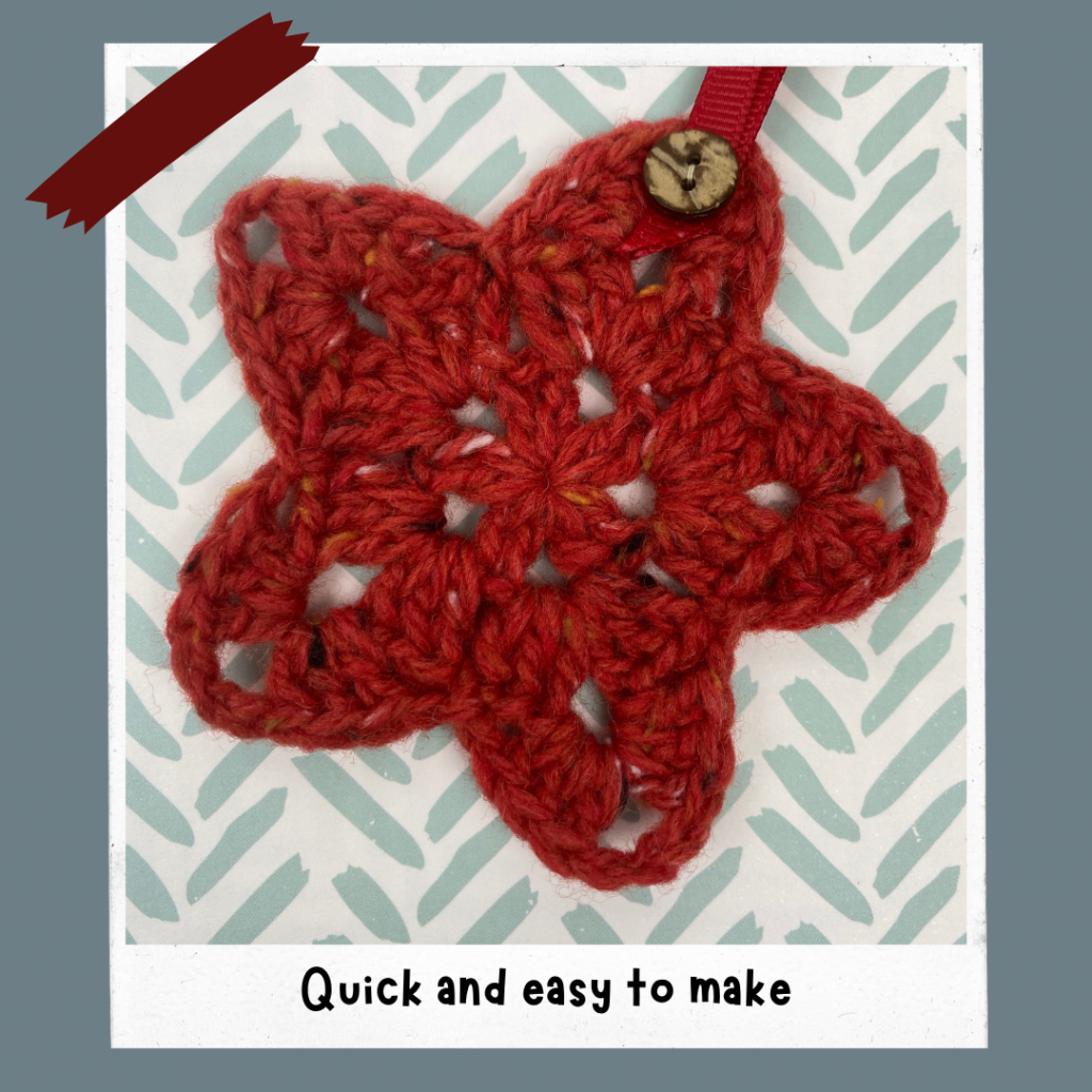 One finished star in Red made from free crochet stars pattern, with small wooden button and red hanging ribbon loop.