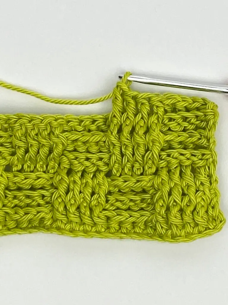 Showing stitch pattern from free crochet washcloth pattern, which is basketweave stitch in green cotton yarn