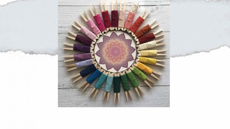 yarn pegs, in a circle in muted rainbow colours