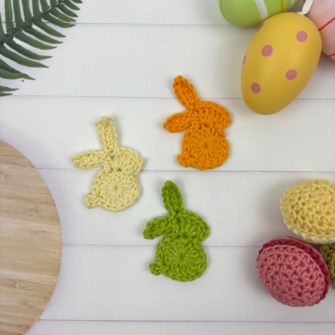 3 crochet bunny motifs made from free pattern, shown in lemon, organ and green yarn.