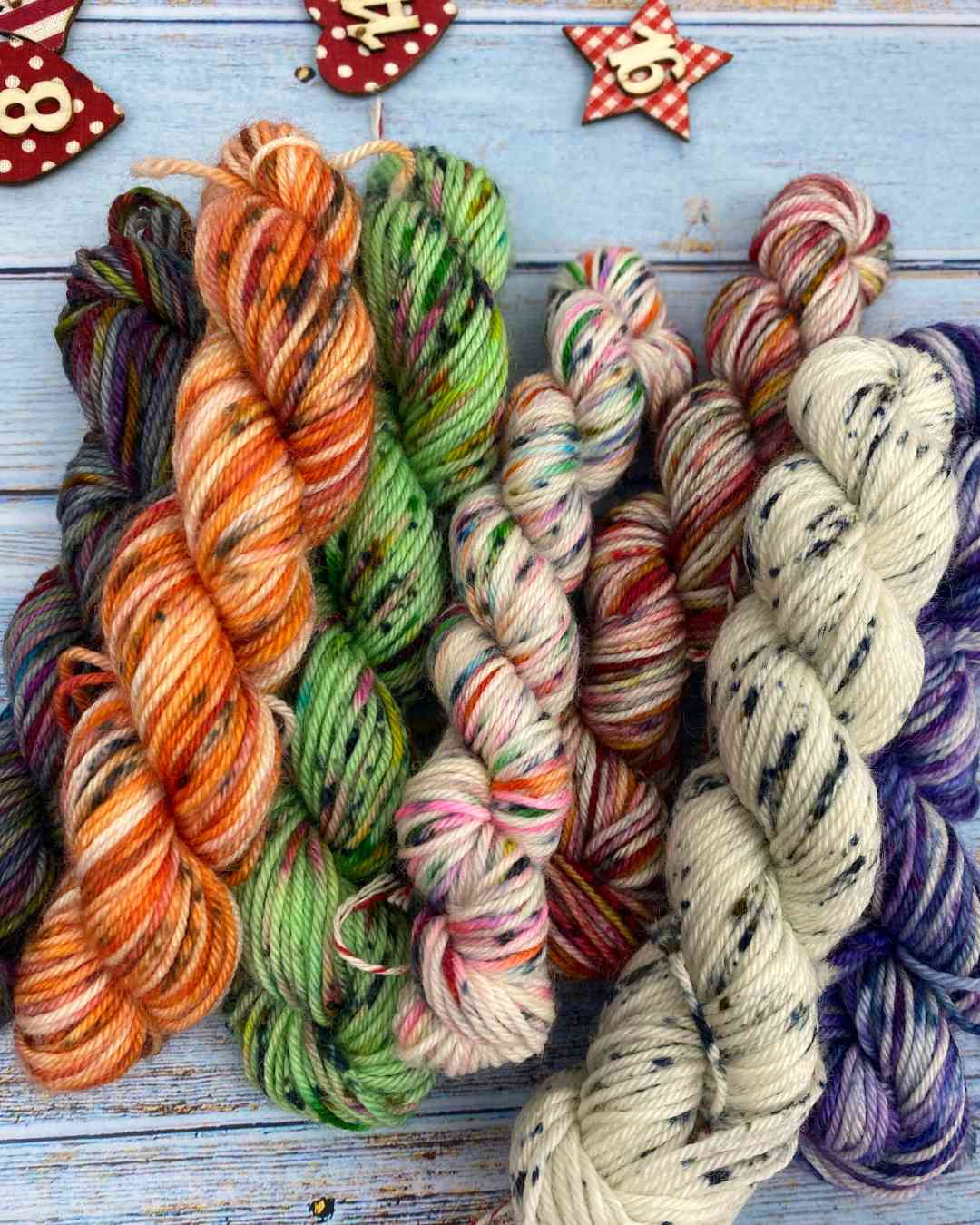 mini skeins of yarn made from scraps in earthy tones with pretty speckles of colour