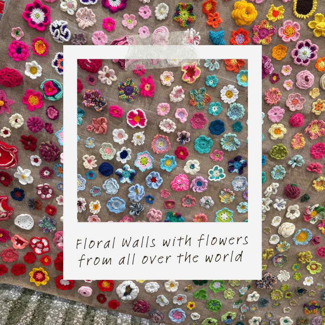 Crochet flowers sewn to fabric, decorating the walls at Yarndale
