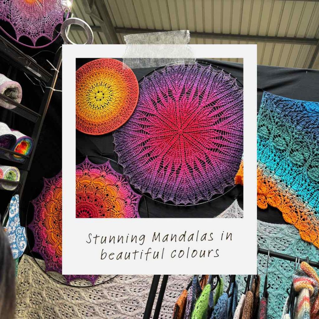 Yarn on display in colourful hand dyed yarn cakes, and rainbow mandalas at Yarndale show, Skipton