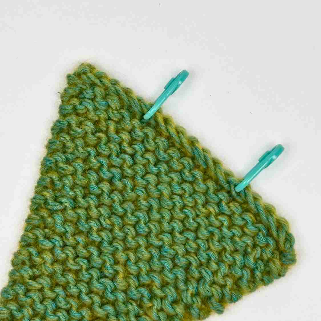 Showing Knitted Christmas Tree with marked stitches for Tree Trunk