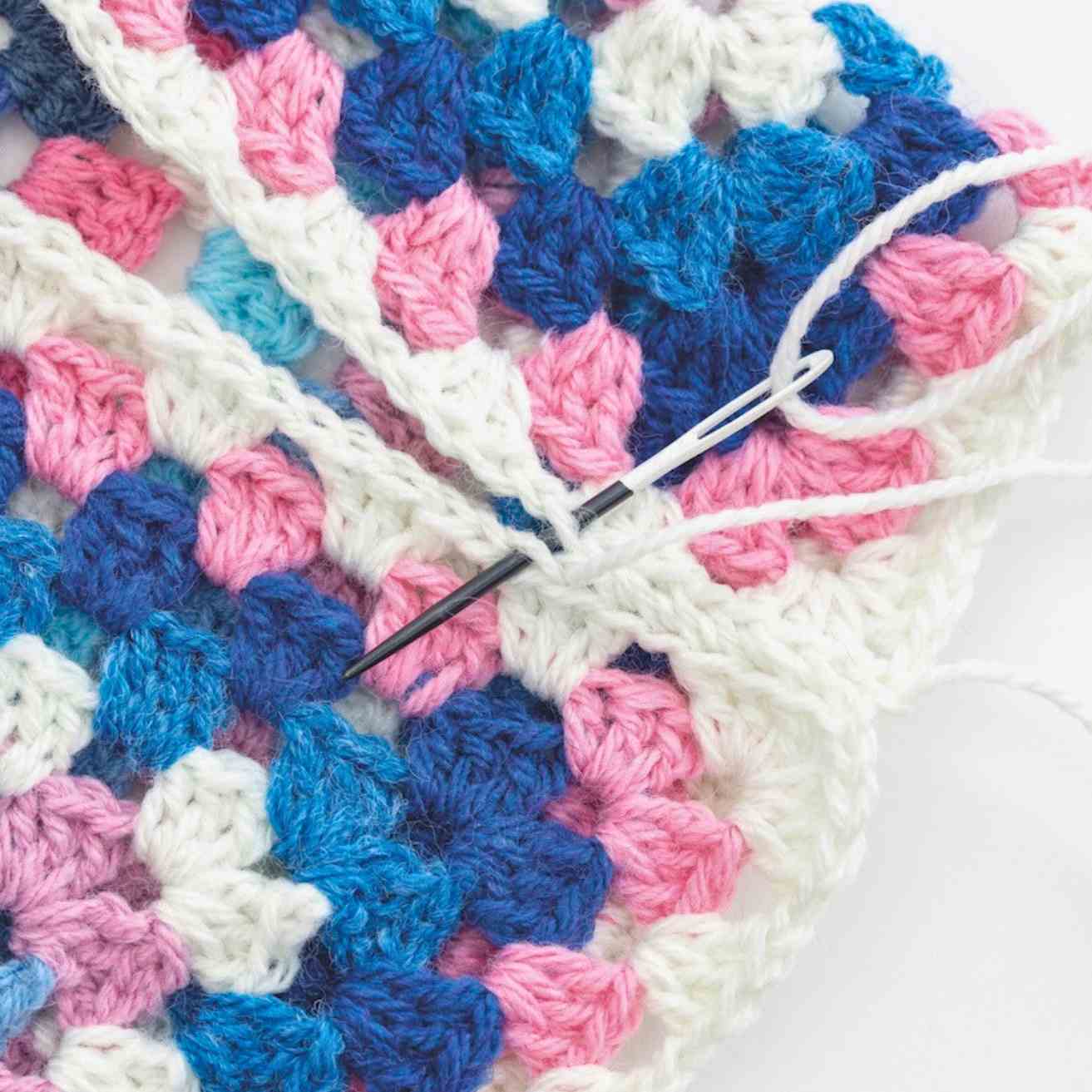 Showing cardigan shoulder seam being sewn