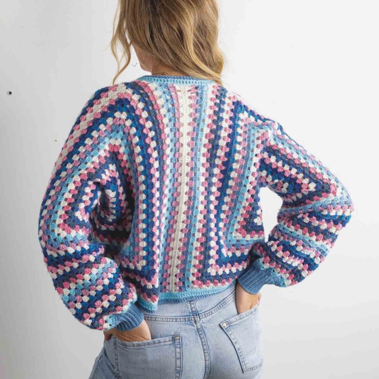 Showing back of cardigan with body widening rows.