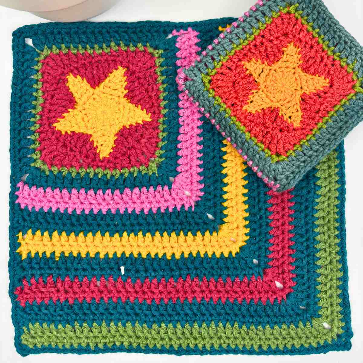 crochet washcloth made from free crochet dishcloth pattern, with a granny square corner featuring a bold yellow star.