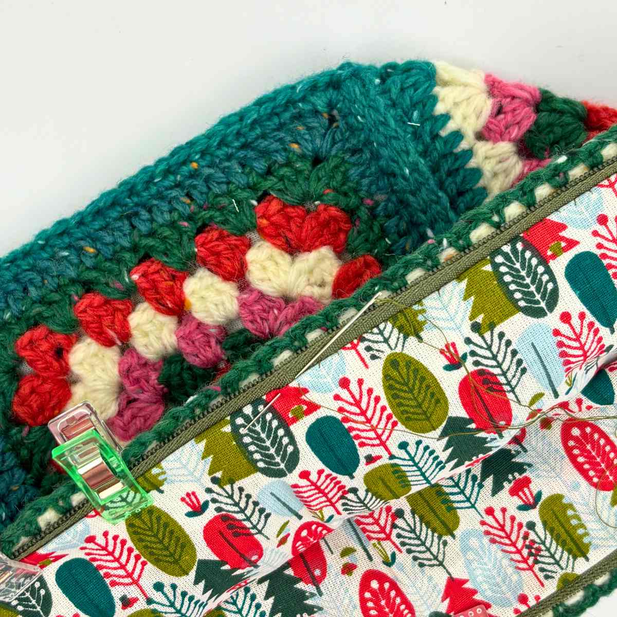 Showing lining attached to inside of bag with small running stitches to line the granny square crossbody bag.