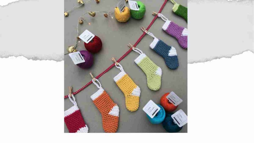 Header for mini crochet stocking pattern showing a garland of mini colourful stockings