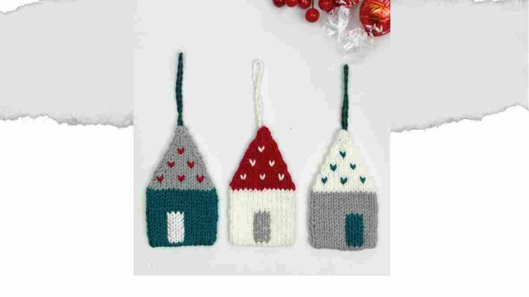 Little Knitted House, in a row of three, knitted in Teal, White and Red yarn.