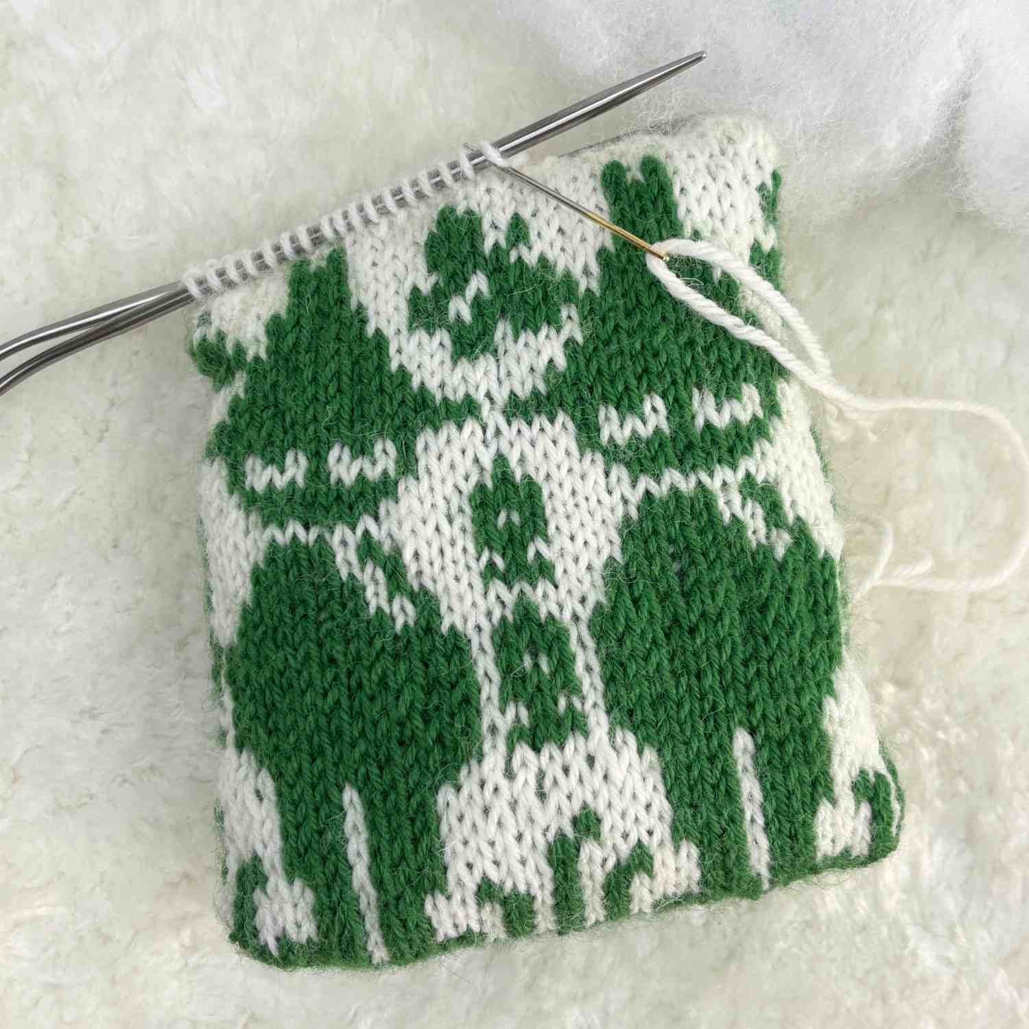 Moomin character Snufkin knitted in stranded knitting on an upcycled knitted sock. Turned into a pin cushion.