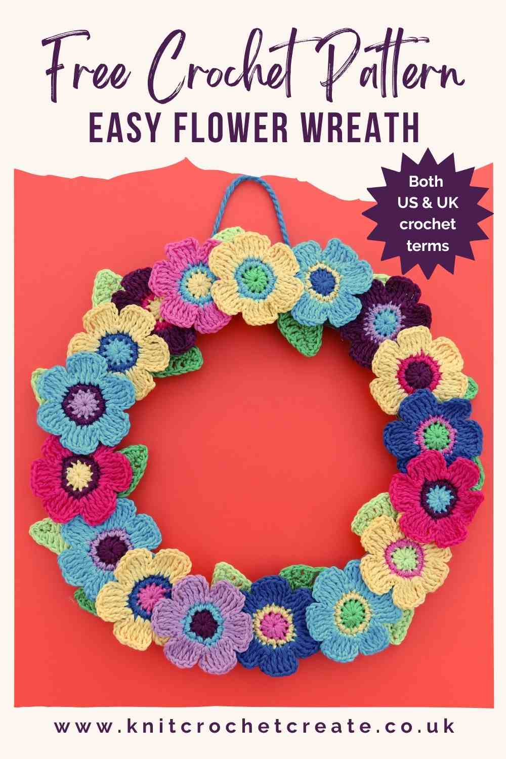 Crochet flower wreath with colourful crochet flowers around a flat wreath base, with green leaves.