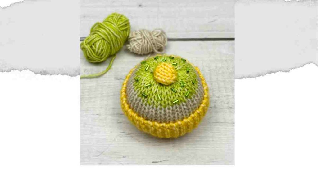 Knitted Cake with a yellow cupcake case and green sprinkles