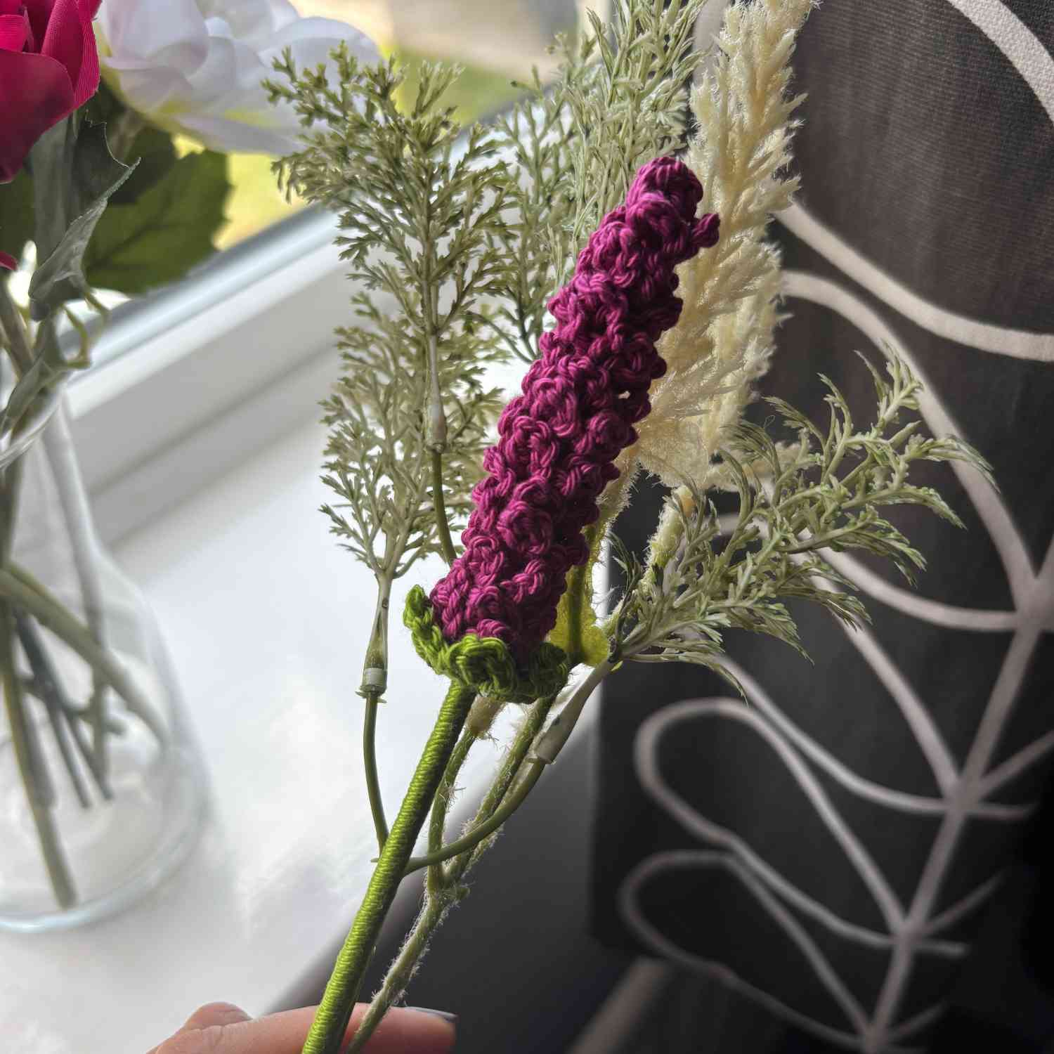 Crochet Lavender Flower being held with foliage for a rustic look.