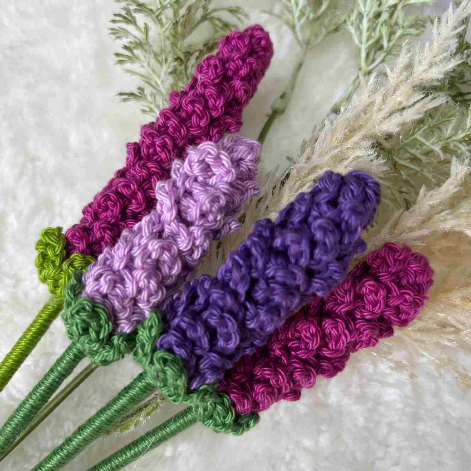 Close up of Lavender Flowers on a cream background with foliage.