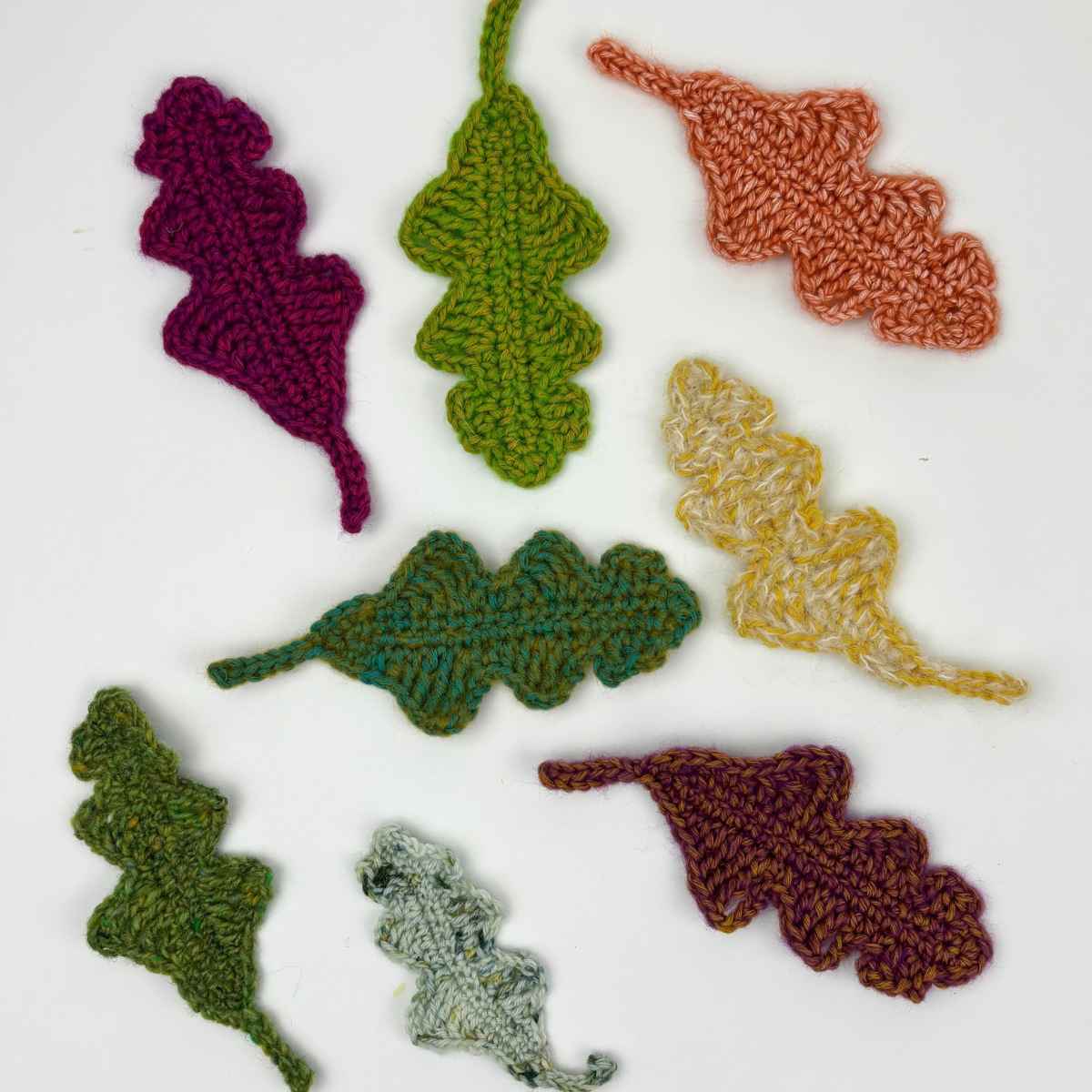 Handmade crochet leaves in different seasonal colours of yarn.