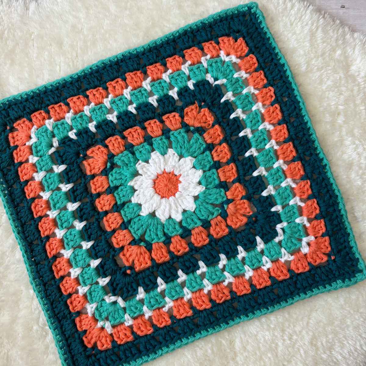 Crochet Granny Square 12inch in size with a Daisy centre and Granny Block Stitch around.